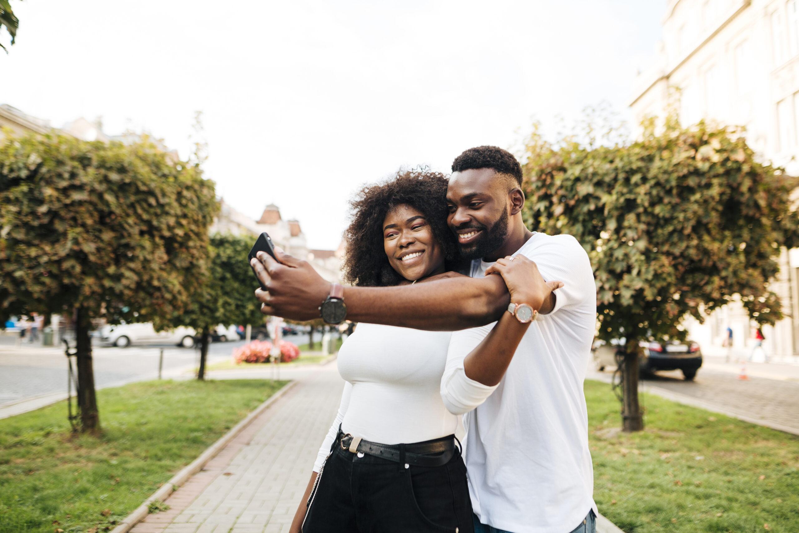 friends-hugging-taking-selfie-scaled